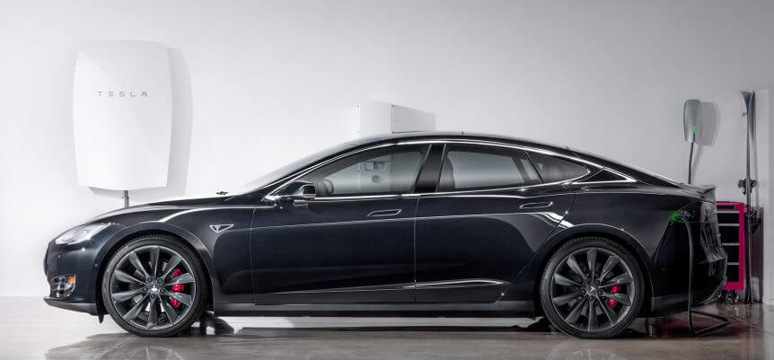 Tesla Powerwall behind the electric Model S charging